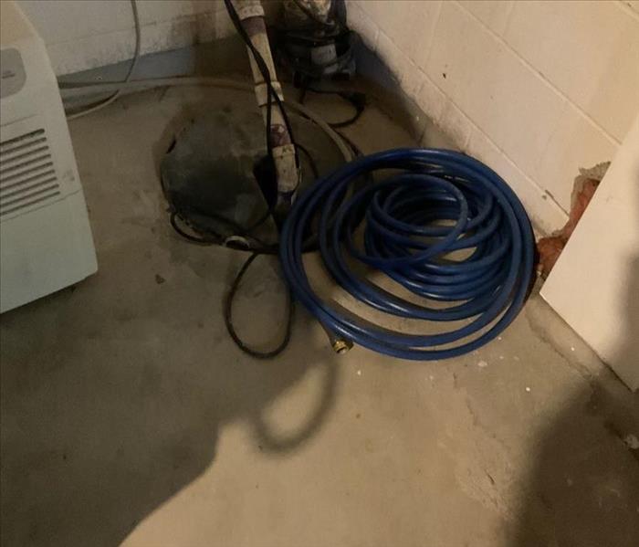 Image of failing sump pump in basement