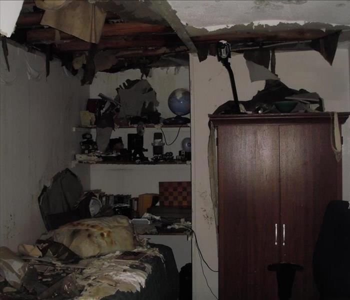 room severely damaged by fire. Affected walls, ceiling and belongings