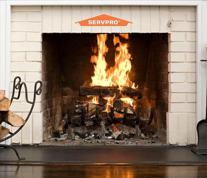 A fireplace burning and SERVPRO logo on top middle