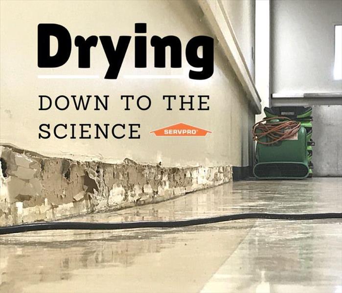 Image of a wet floor with equipment and text "drying down to the science" and SERVPRO logo
