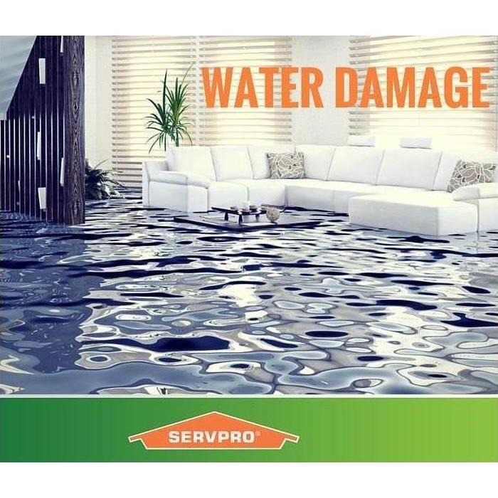 A living room flooded with words water damage and SERVPRO logo